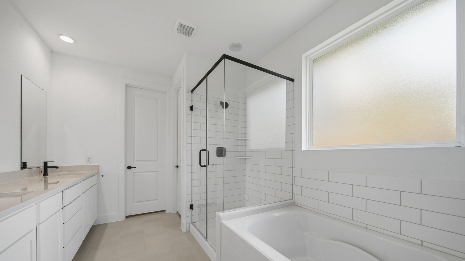 Primary bathroom with tile shower and semi-frameless glass and separate toilet room in Magnolia TX