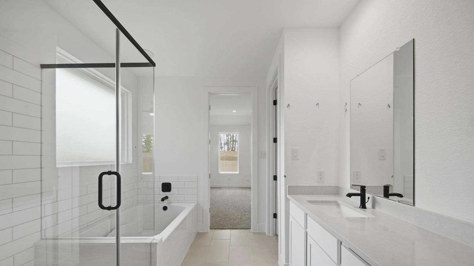 Primary bathroom with tile shower and semi-frameless glass and separate toilet room in Magnolia TX