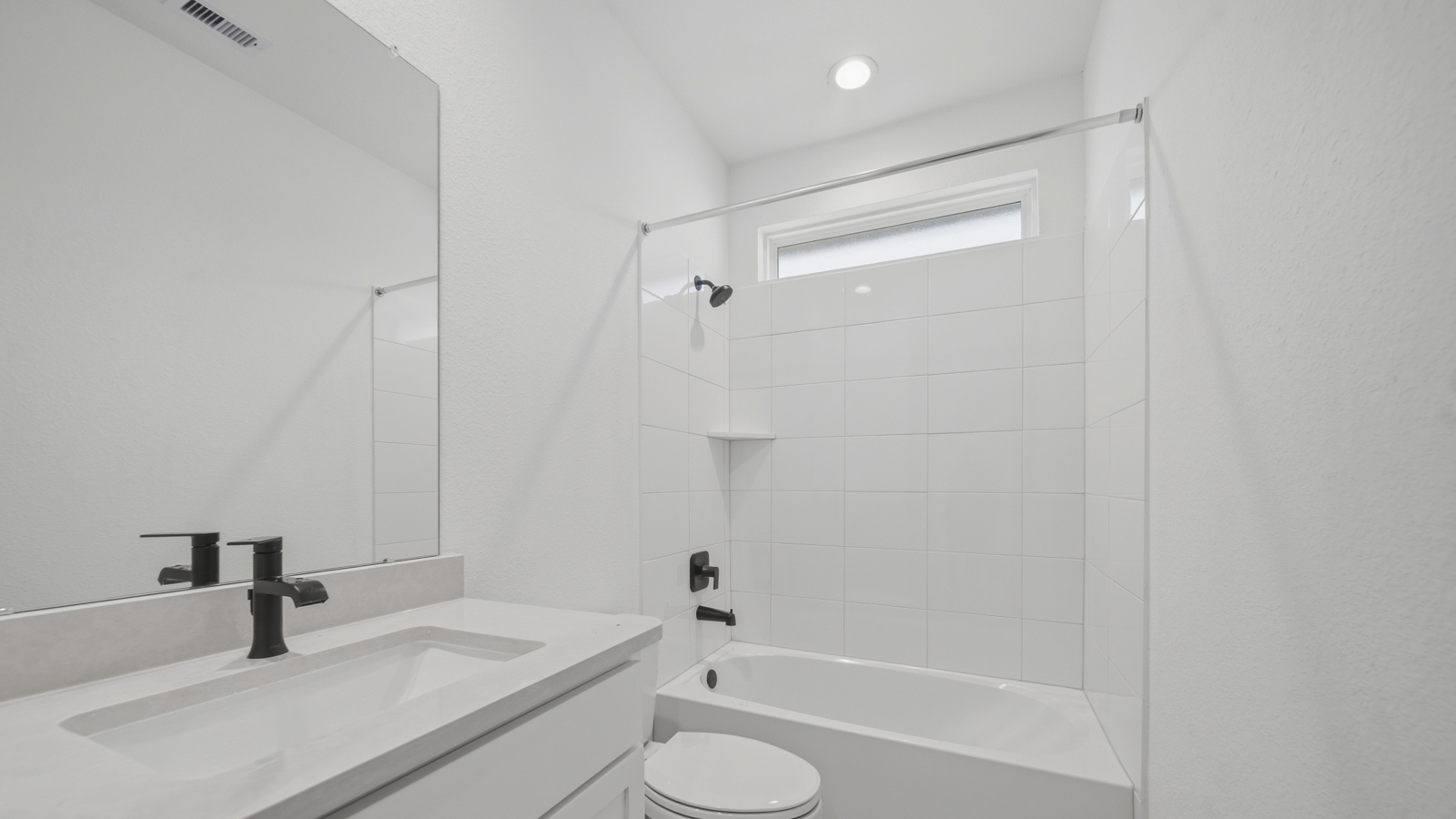 Secondary bathroom with tub/shower combo with quartz counter tops in Magnolia TX