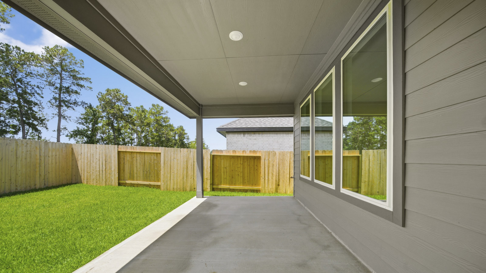 covered patio with jamies hardie siding and overhead lighting
