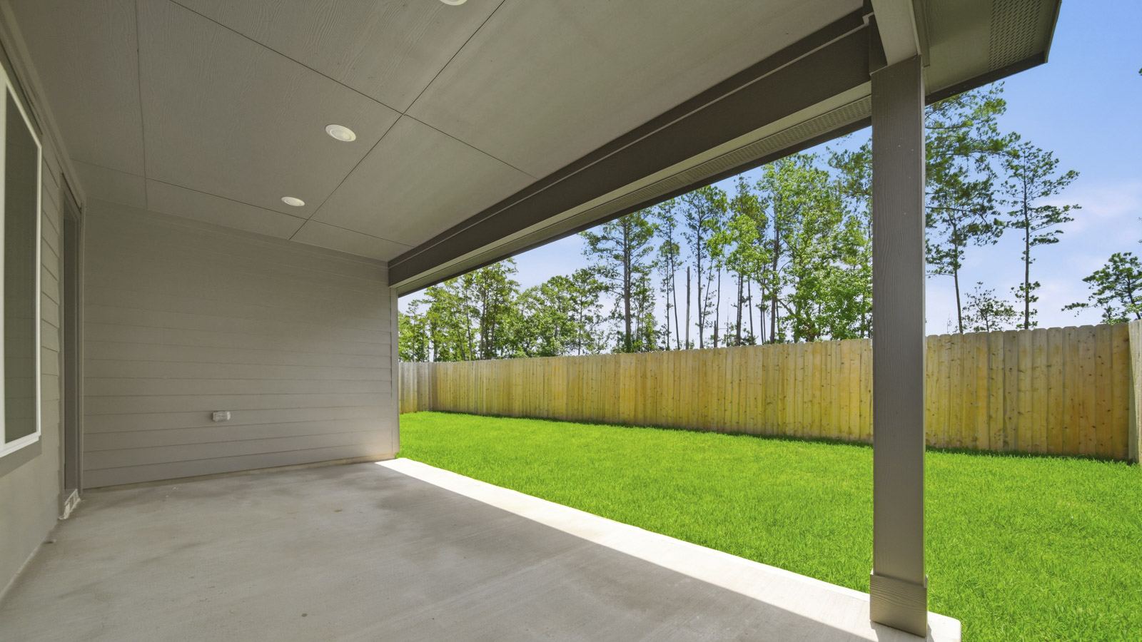 covered patio with jamies hardie siding and overhead lighting