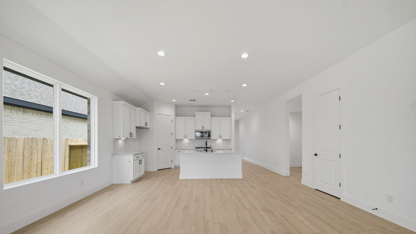 Spacious living area with vinyl flooring and bright windows in Magnolia TX