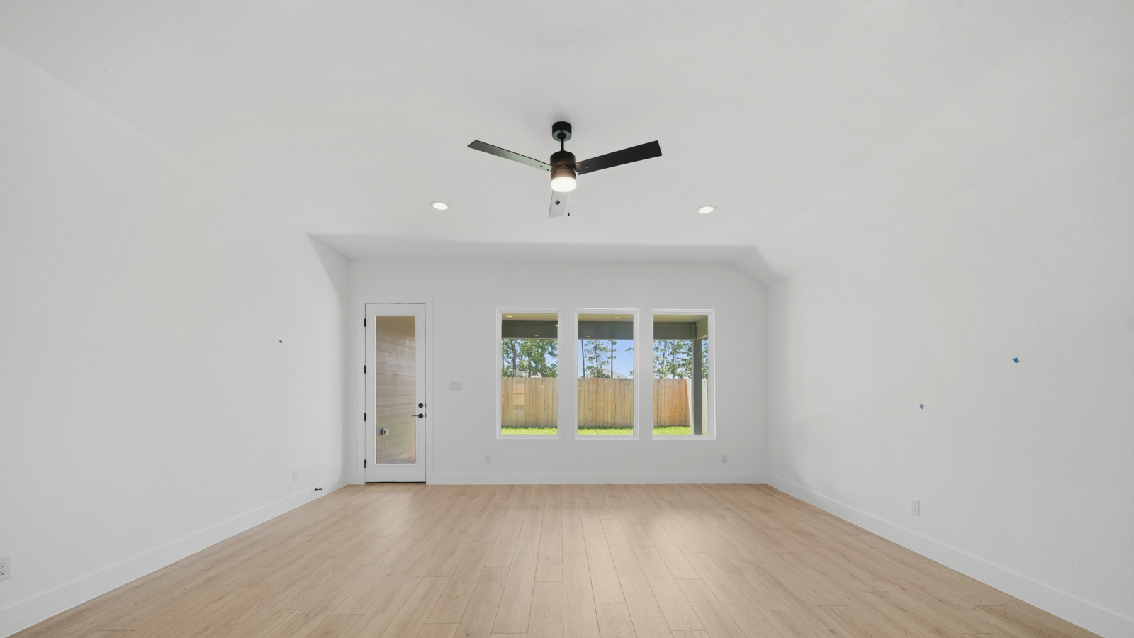 Spacious living area with vinyl flooring and bright windows in Magnolia TX