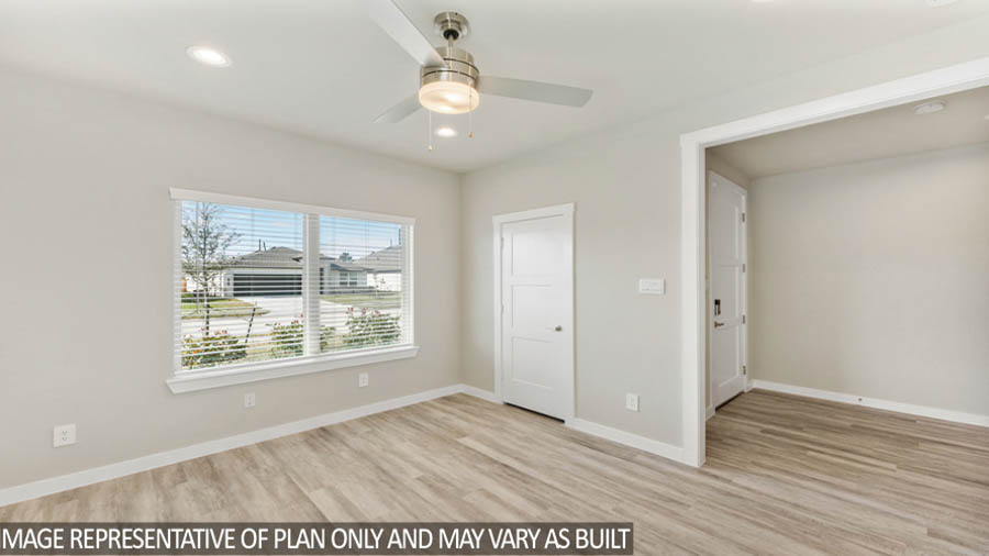 Spacious living area with vinyl flooring