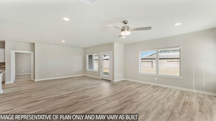 Spacious living area with vinyl flooring