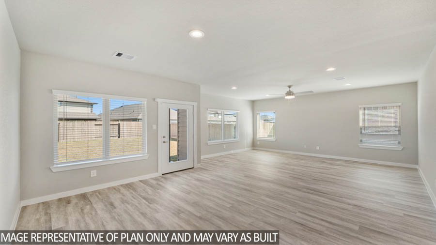 Spacious living area with vinyl flooring
