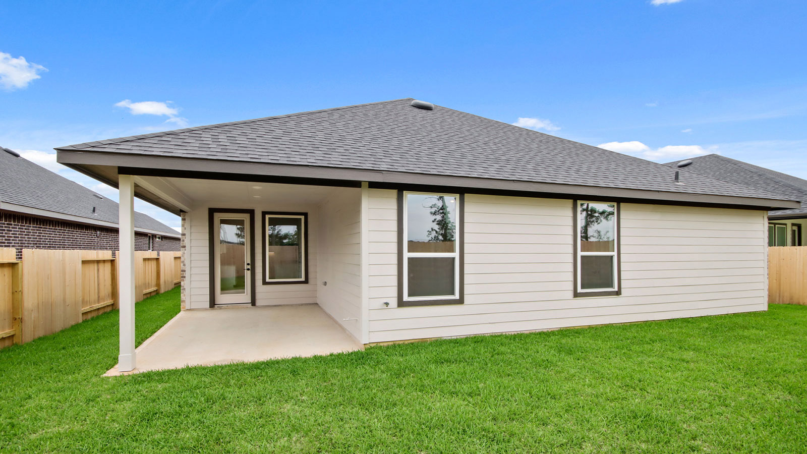 covered patio with jamies hardie siding and overhead lighting