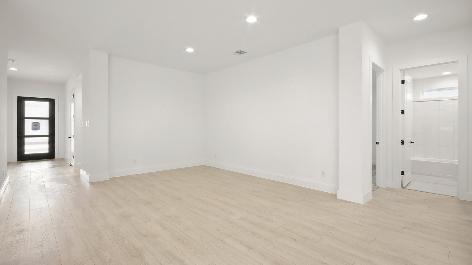 Spacious living area with vinyl flooring and bright windows in Magnolia TX
