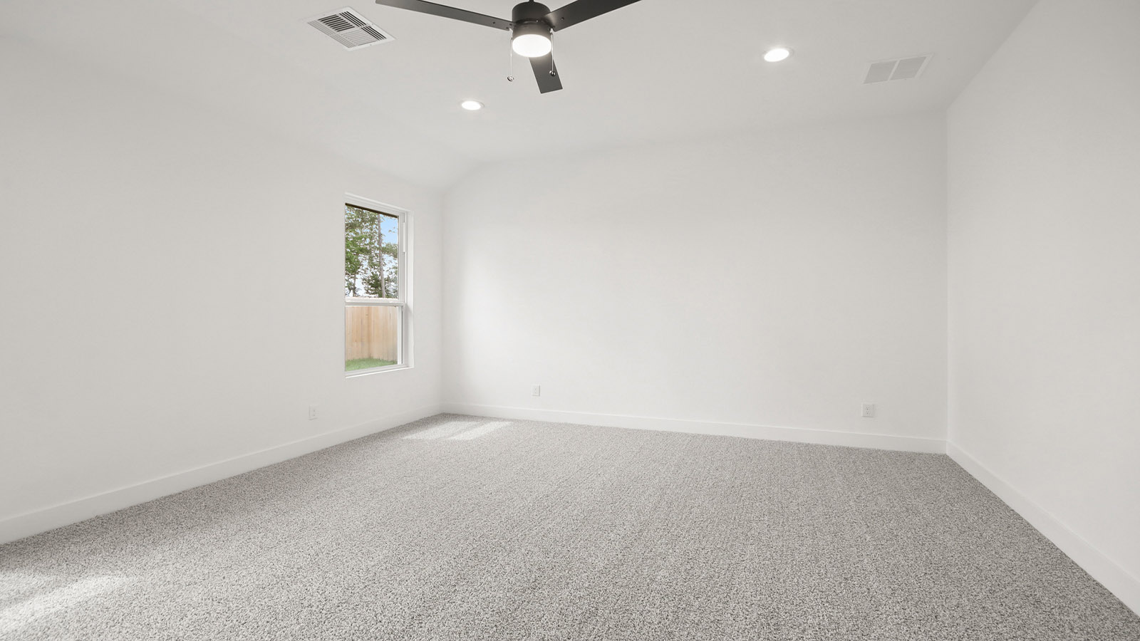 Large Primary bedroom with shag carpet flooring and bright window