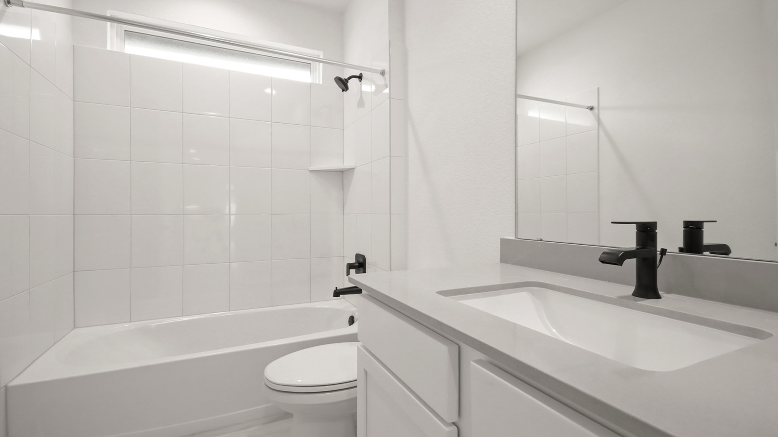 Secondary bathroom with tub/shower combo with quartz counter tops in Magnolia TX