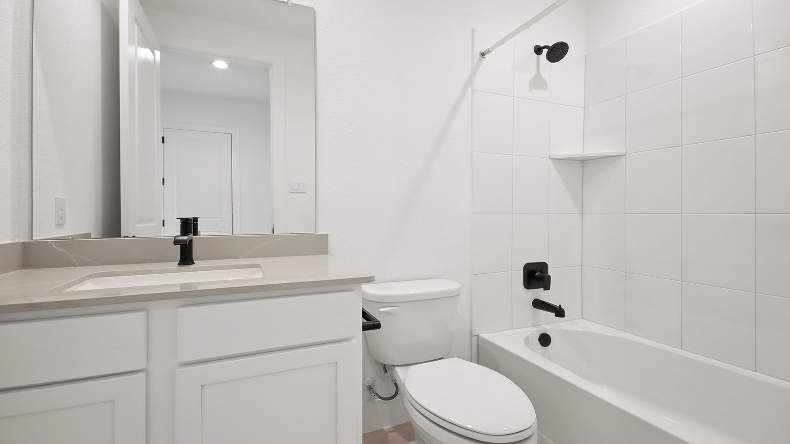 Secondary bathroom with tub/shower combo with quartz counter tops in Magnolia TX