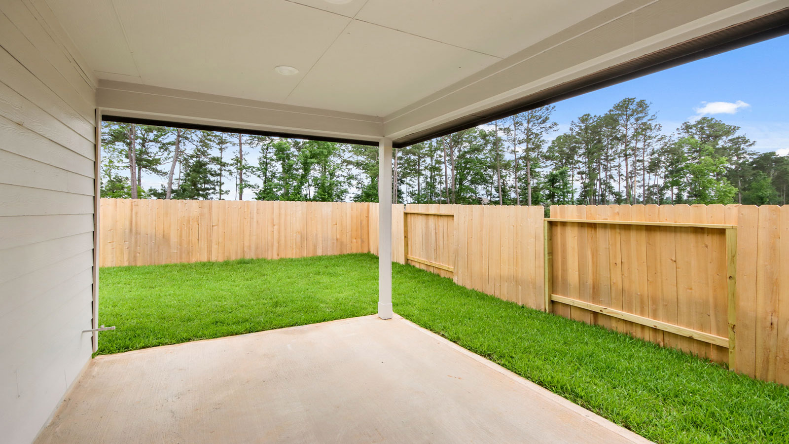 covered patio with jamies hardie siding and overhead lighting