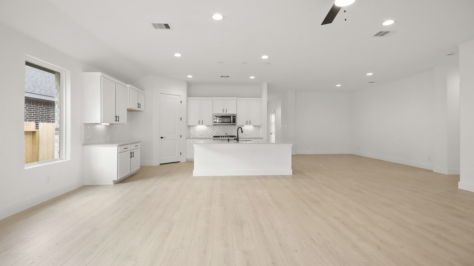 Spacious living area with vinyl flooring and bright windows in Magnolia TX
