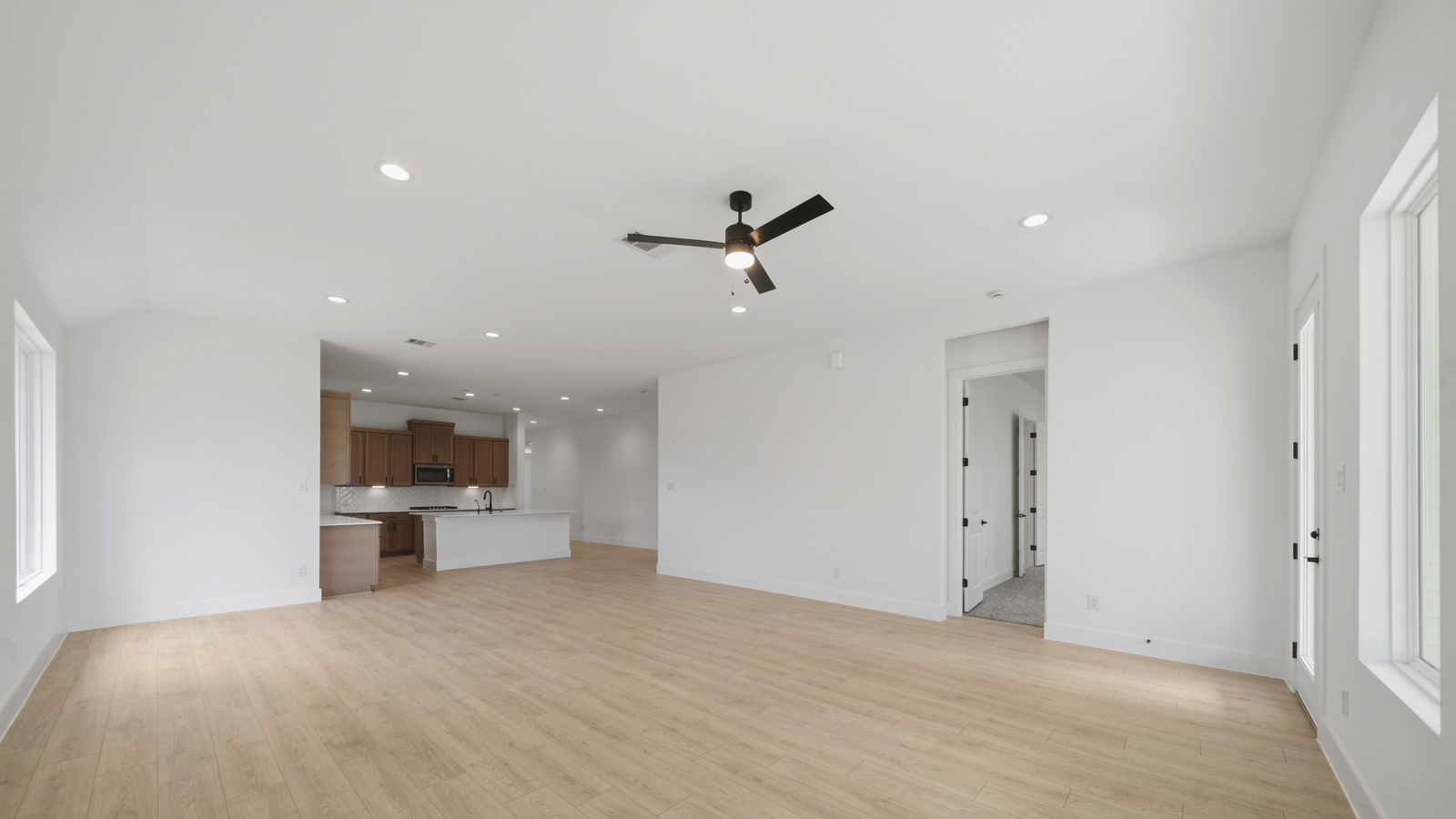Spacious living area with vinyl flooring and bright windows in Magnolia TX