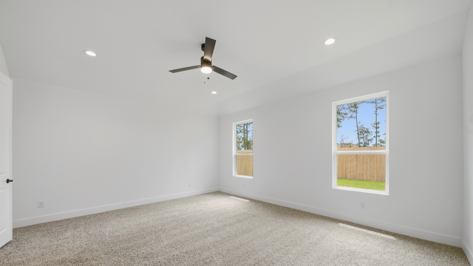 Large Primary bedroom with shag carpet flooring and bright window