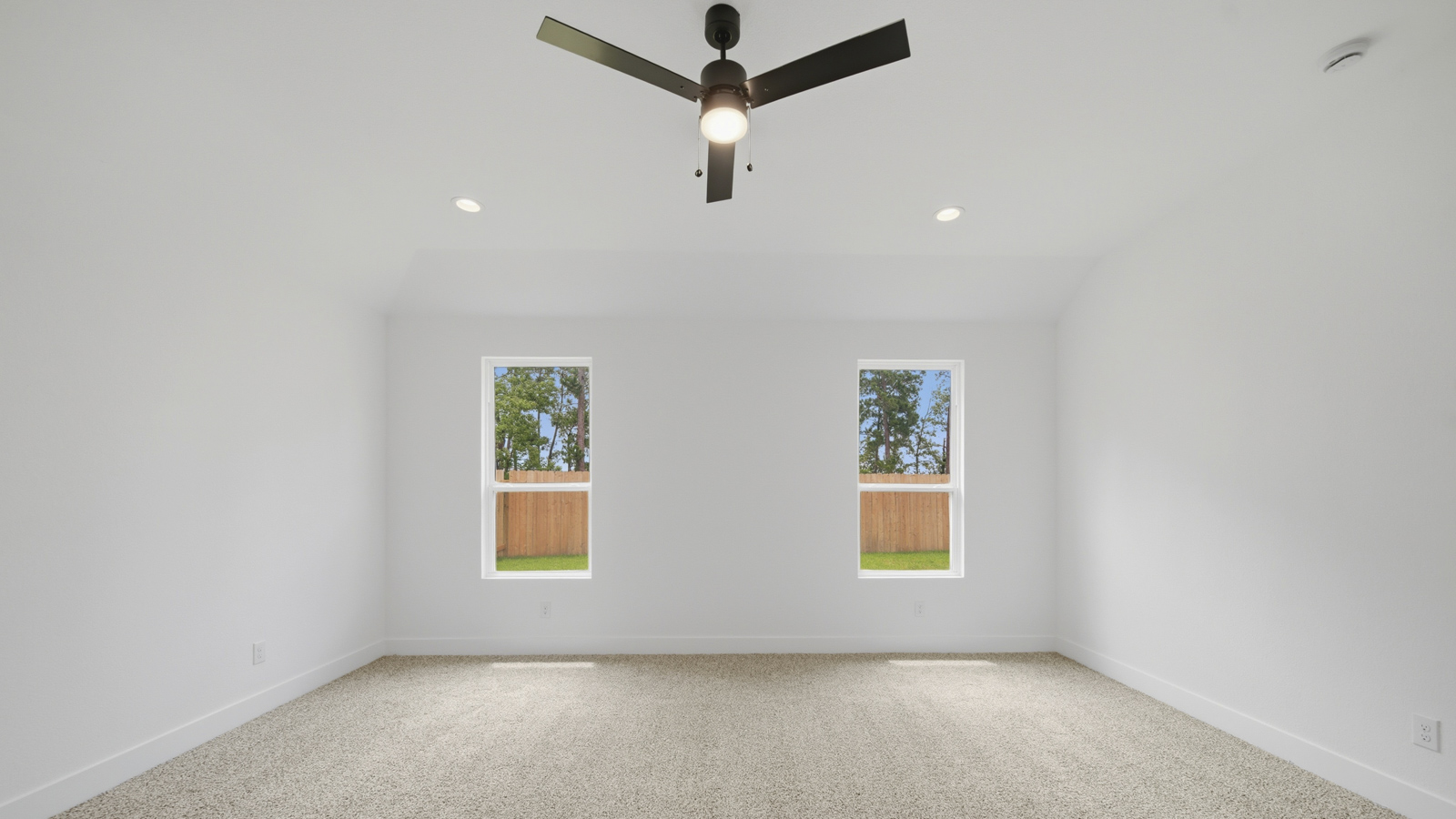 Large Primary bedroom with shag carpet flooring and bright window