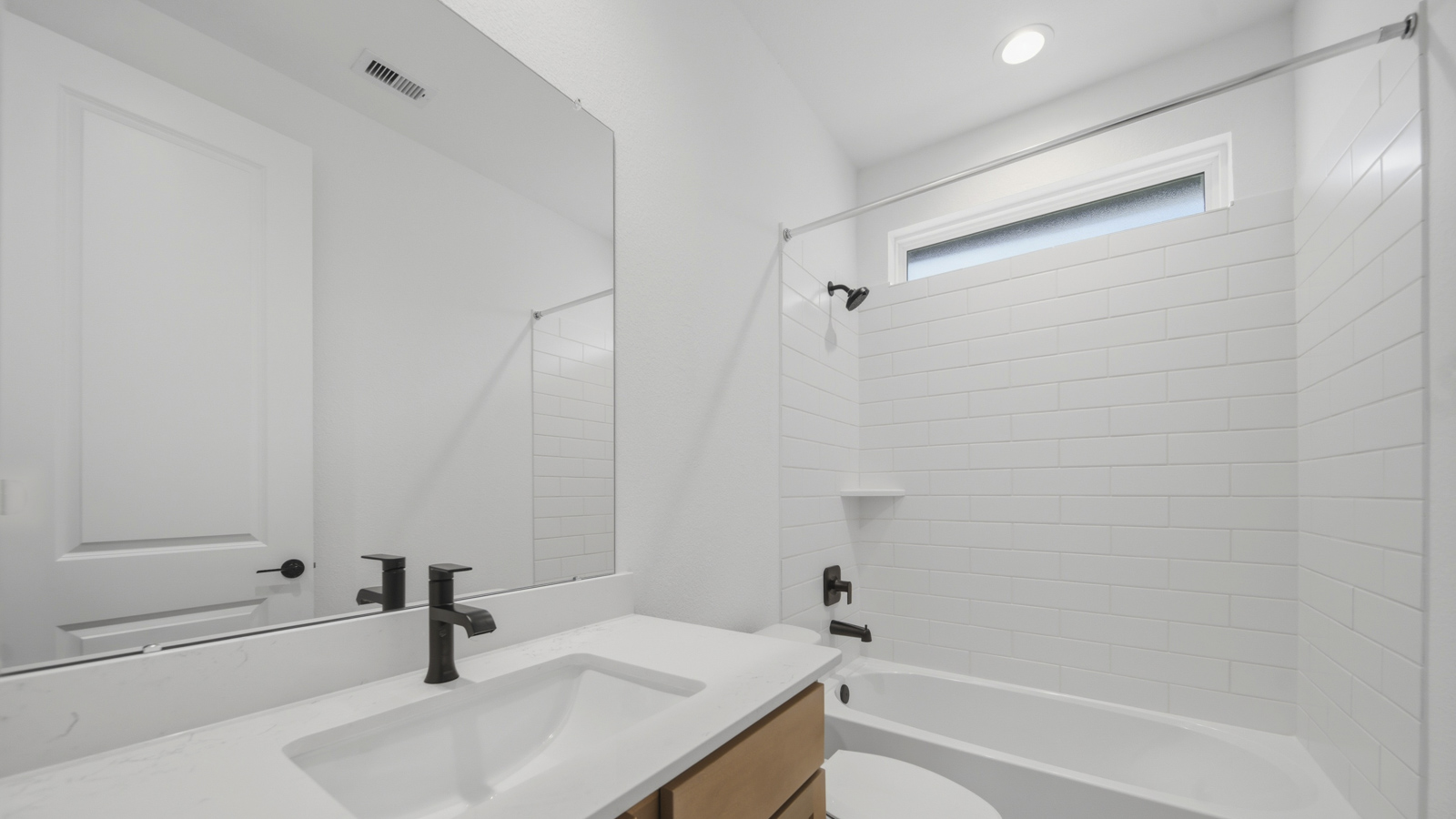 Secondary bathroom with tub/shower combo with quartz counter tops in Magnolia TX