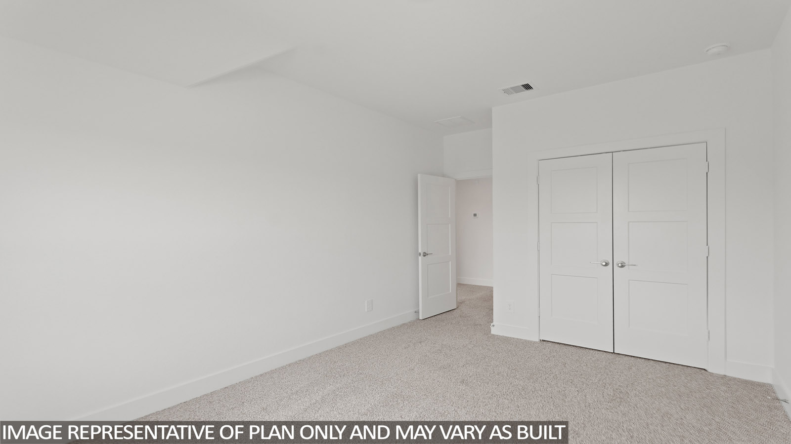 Secondary bedroom with carpet flooring