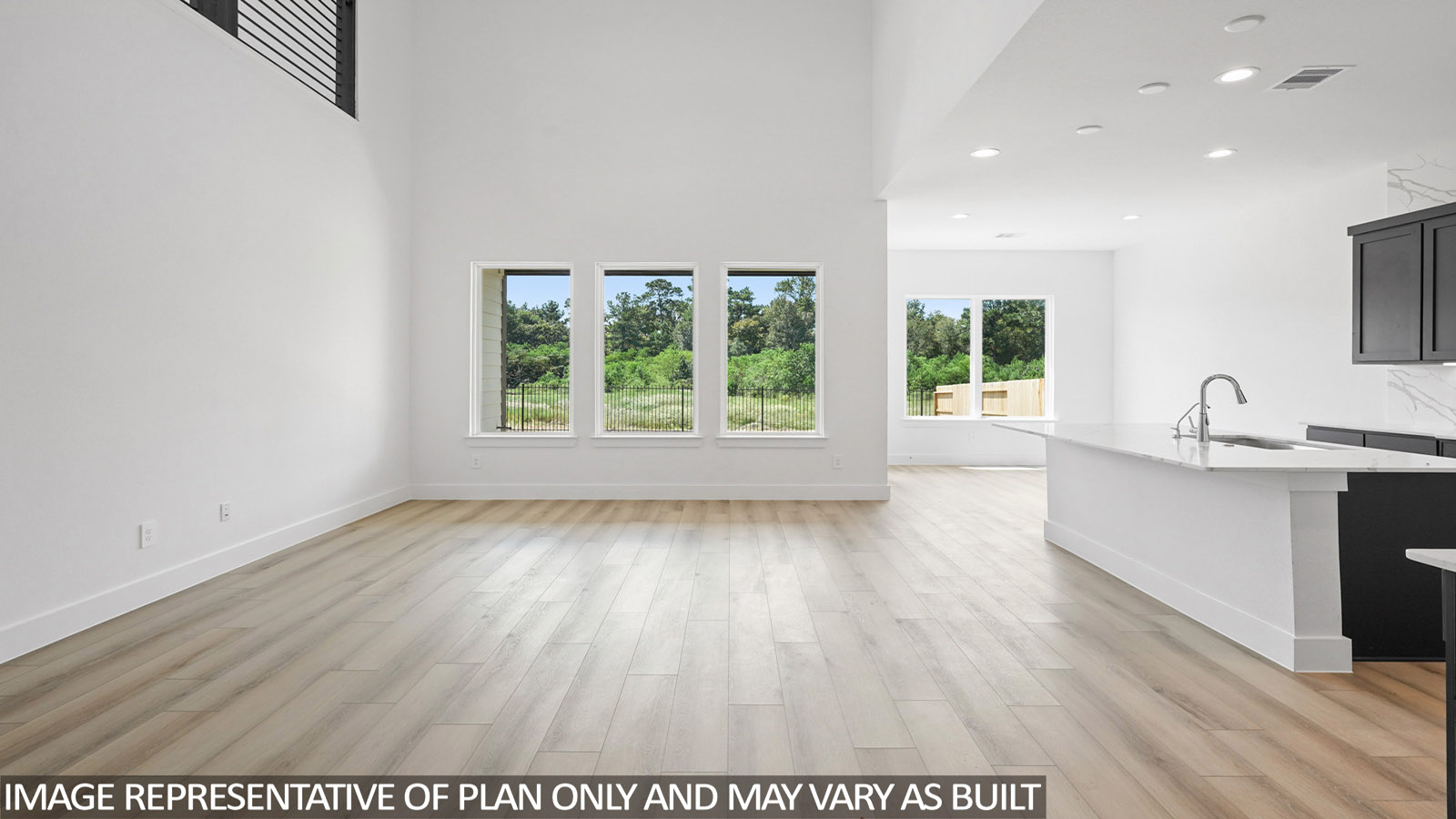 Spacious living area with vinyl flooring