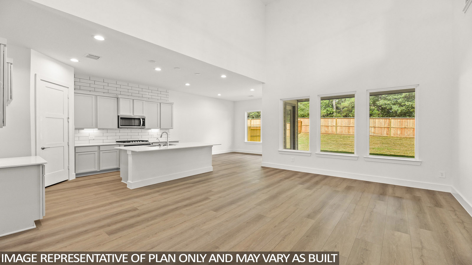 open concept living area with vinyl flooring, large windows and high ceilings