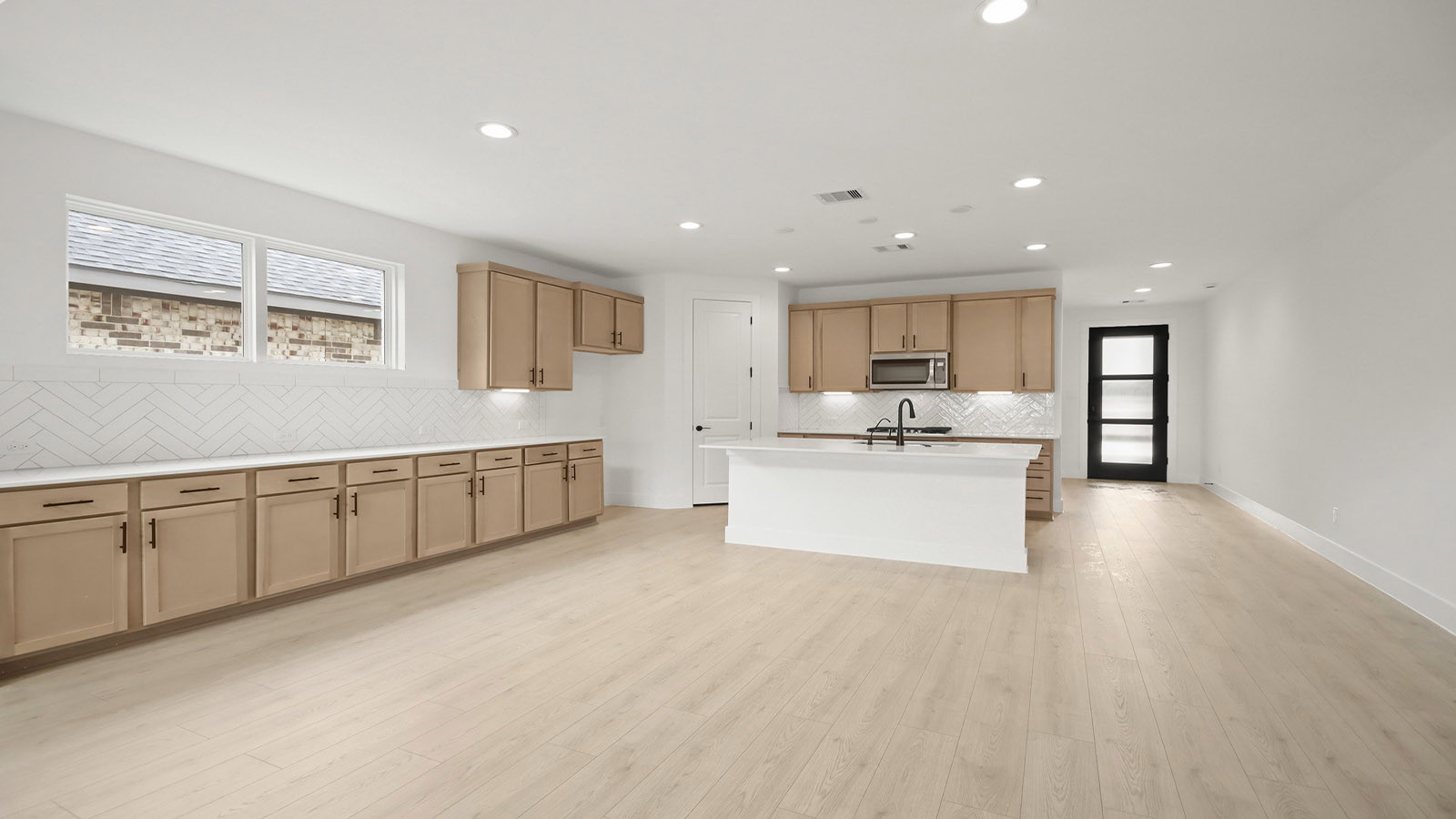 L- shaped kitchen with an island and quartz counter tops