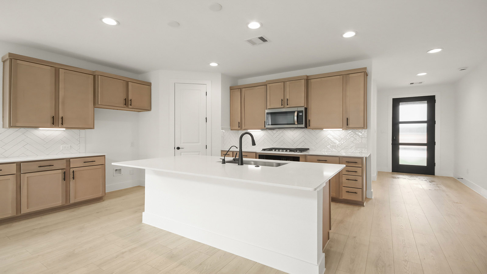 L- shaped kitchen with an island and quartz counter tops