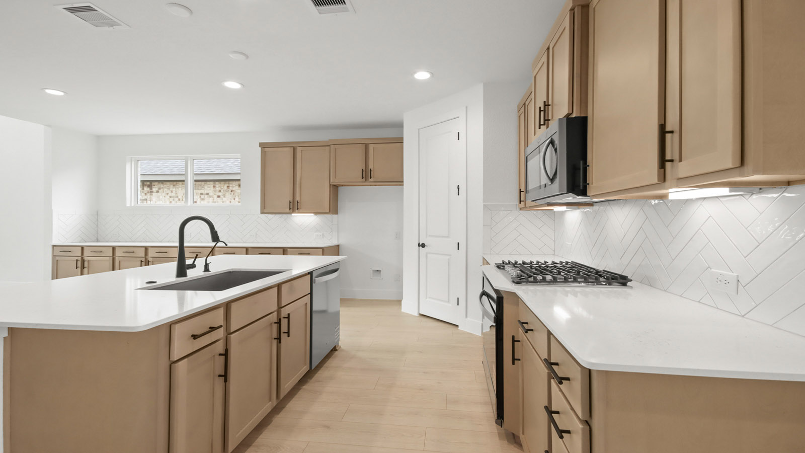L- shaped kitchen with an island and quartz counter tops