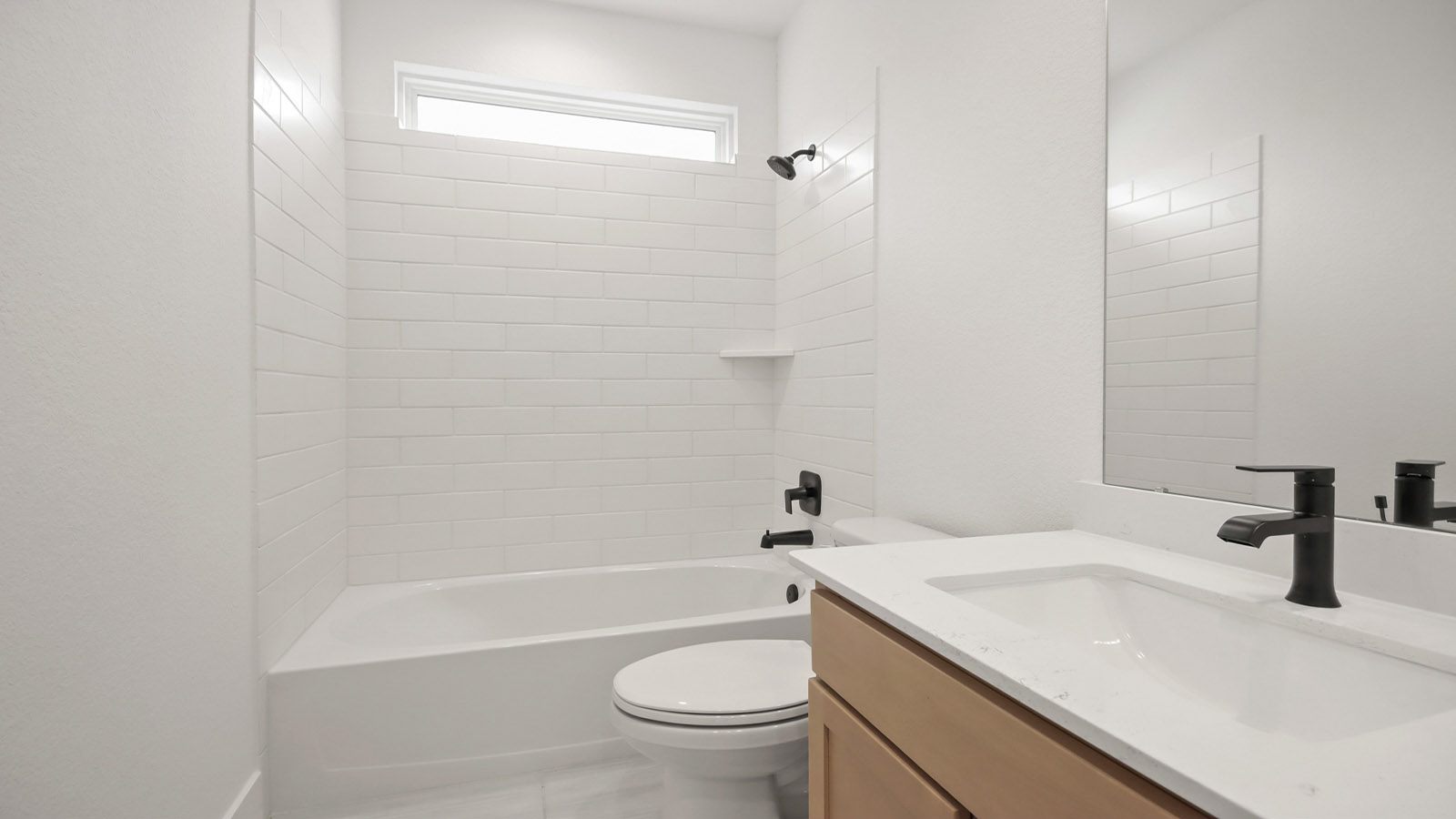 Secondary bathroom with tub/shower combo with quartz counter tops in Magnolia TX