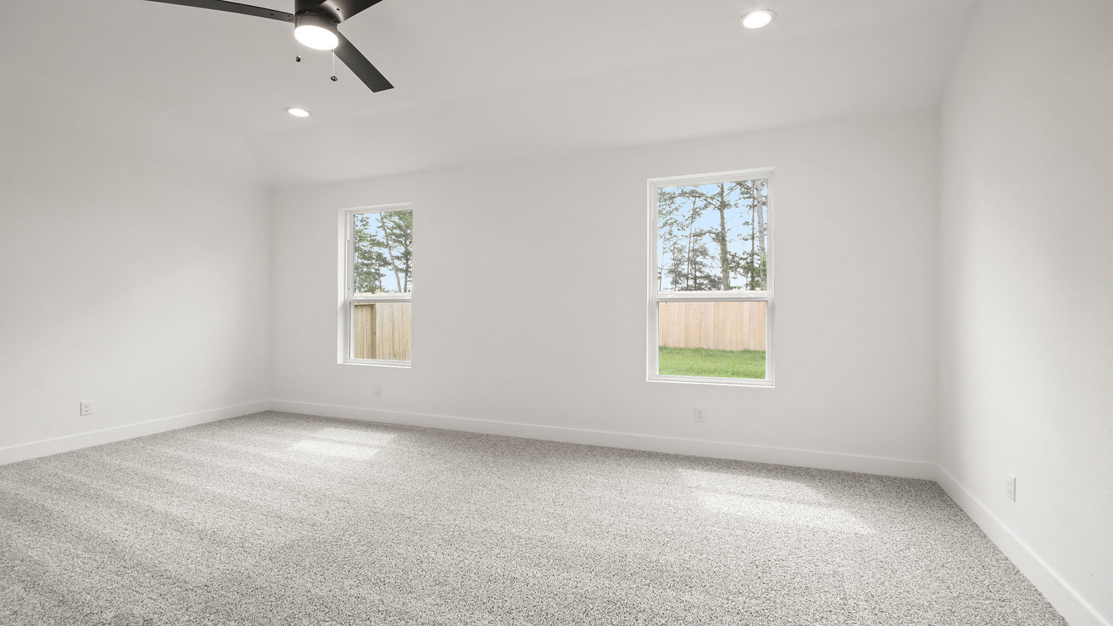 Large Primary bedroom with shag carpet flooring and bright window