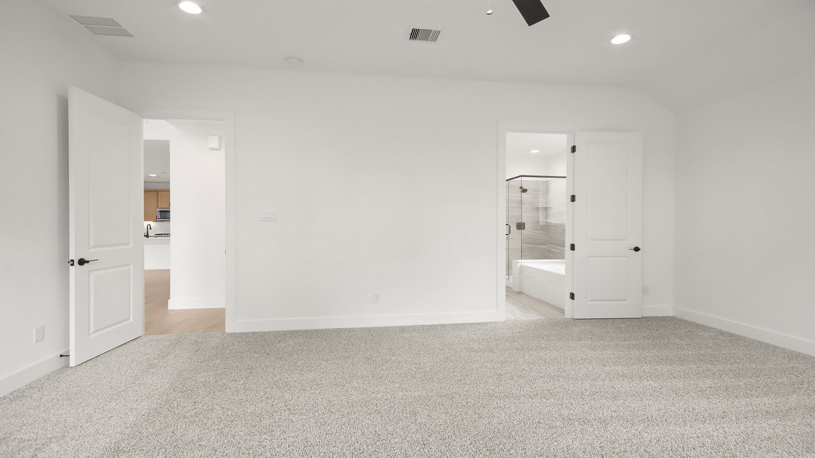 Large Primary bedroom with shag carpet flooring and bright window