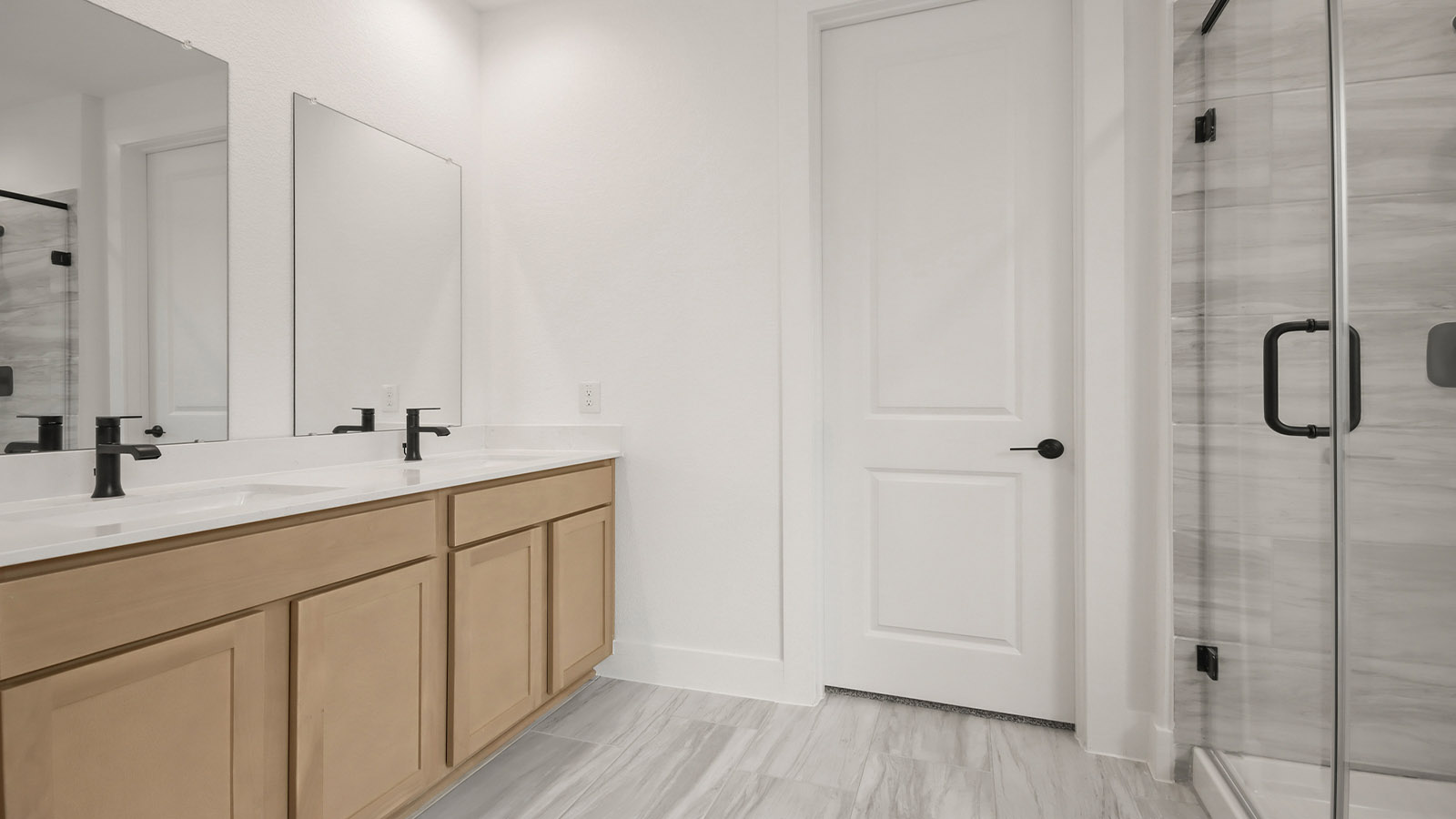Primary bathroom with soaker tub and tile shower with semi frameless glass in Magnolia TX