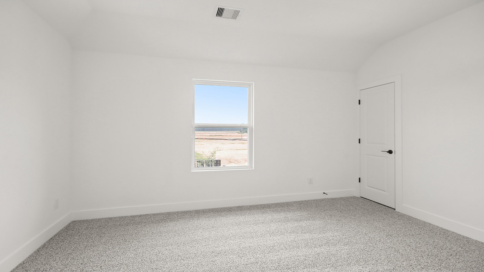 Second level secondary bedroom with carpet flooring and bright window