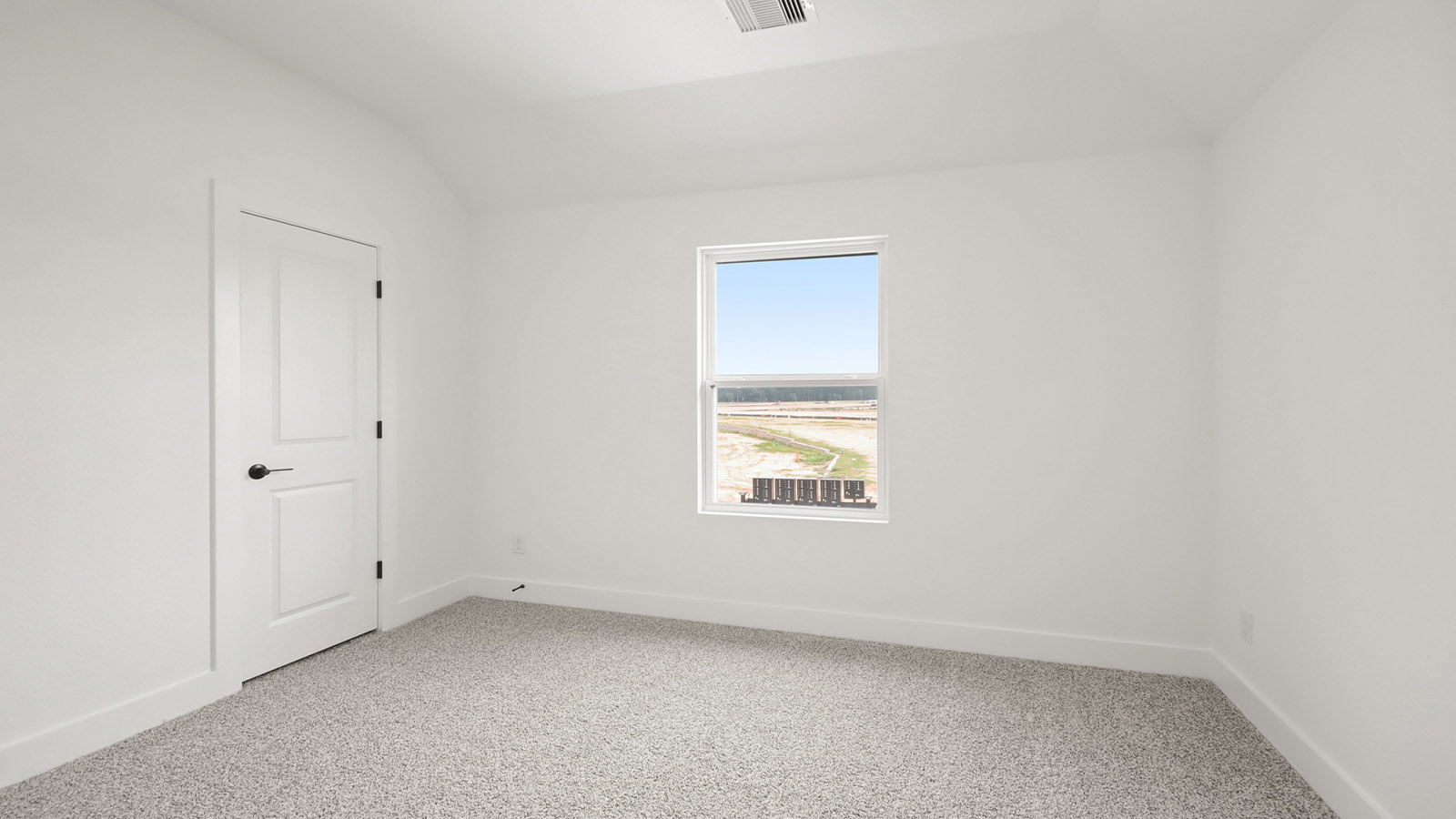 Second level secondary bedroom with carpet flooring and bright window