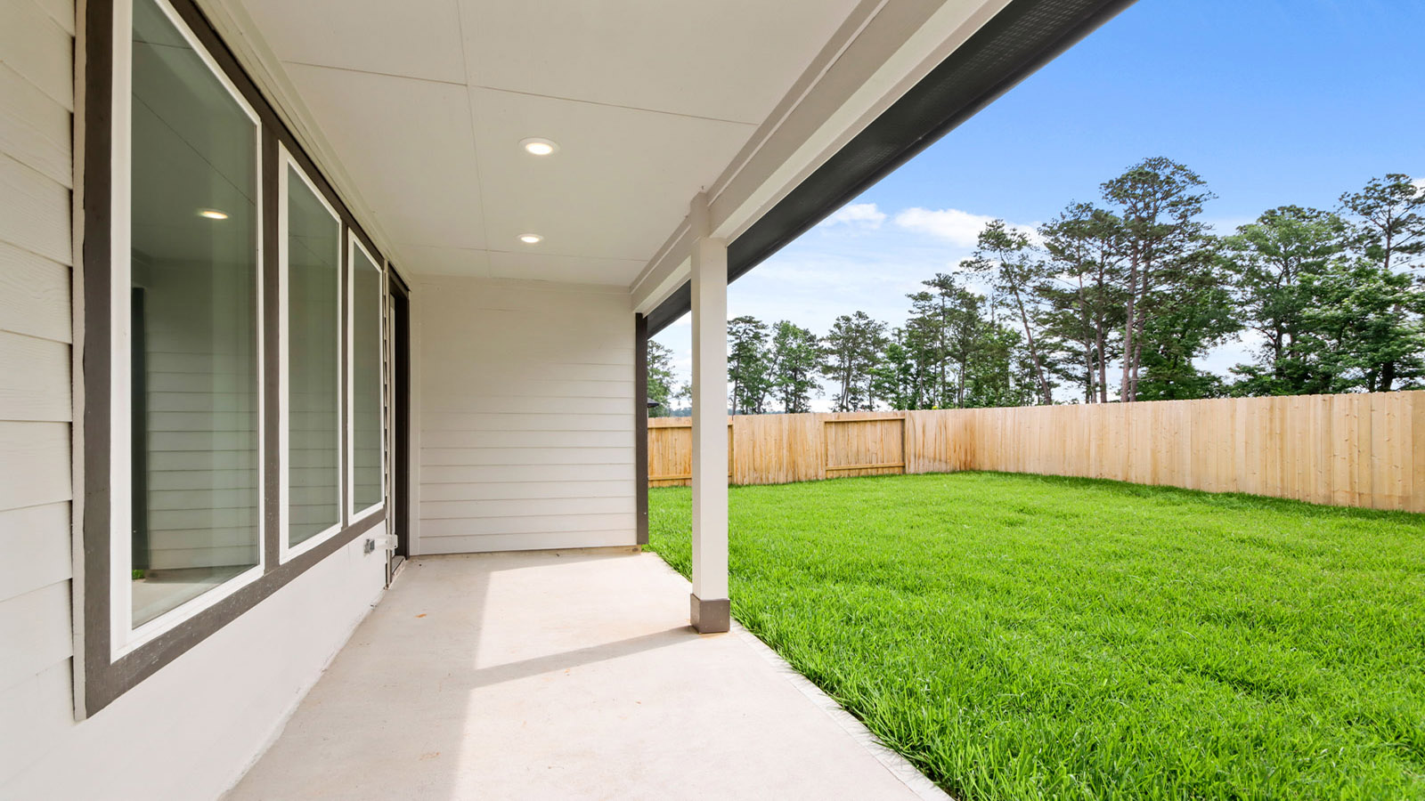 covered patio with jamies hardie siding and overhead lighting