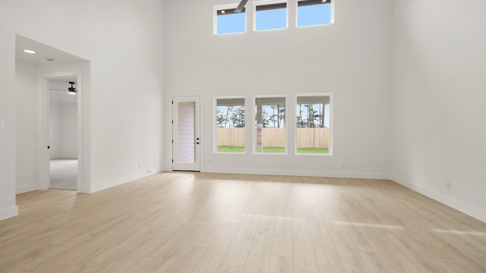 Spacious living area with vinyl flooring and bright windows in Magnolia TX
