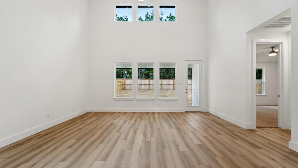 open concept living and dining area with high ceilings, large windows, and vinyl flooring