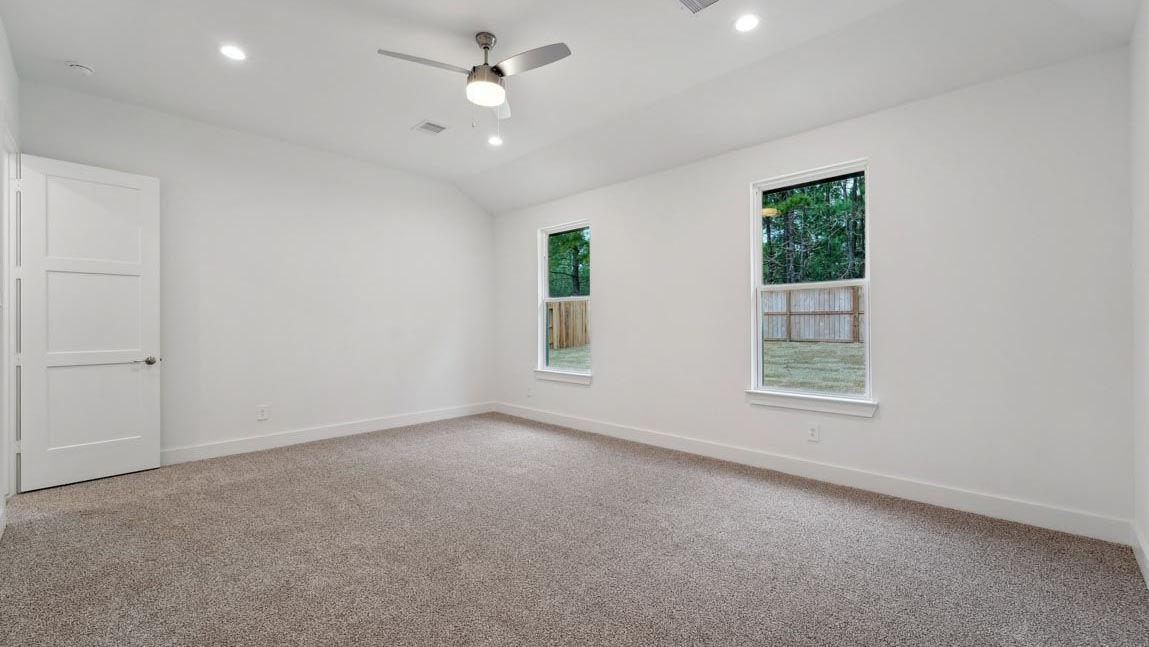 bedroom with carpet flooring and windows