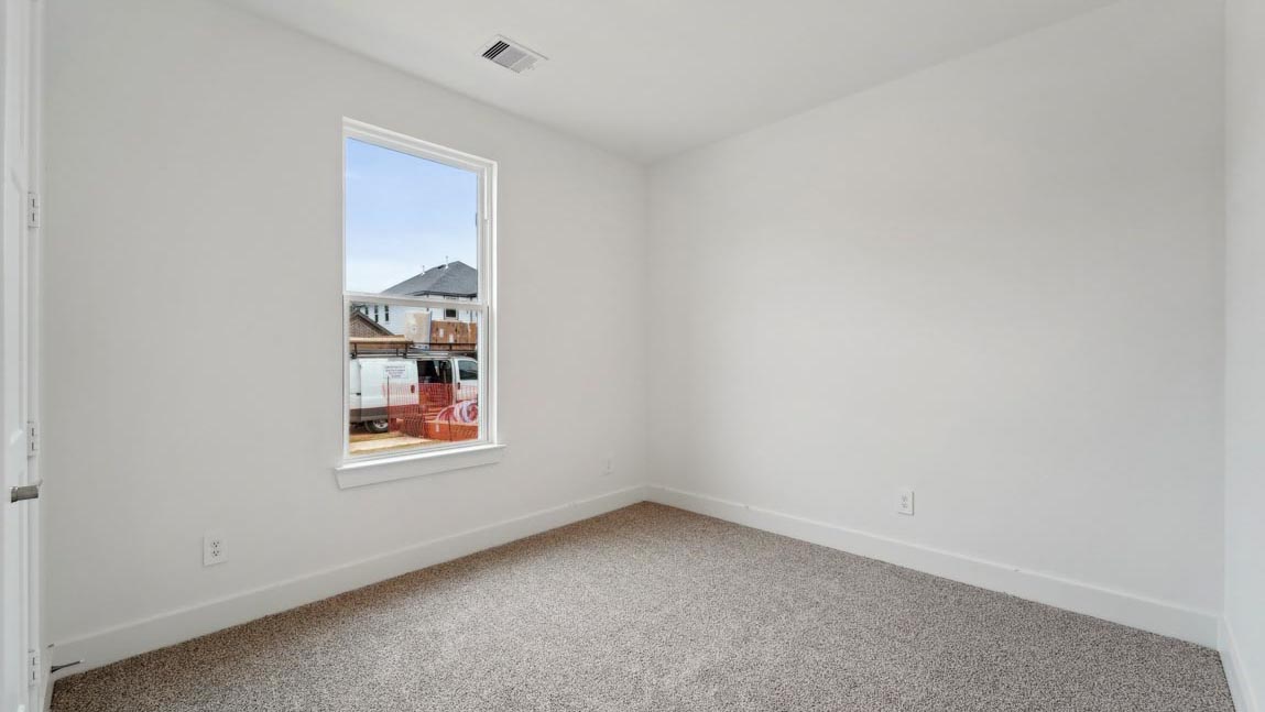 bedroom with carpet flooring and windows