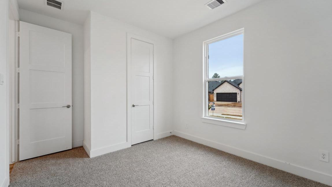 bedroom with carpet flooring and windows