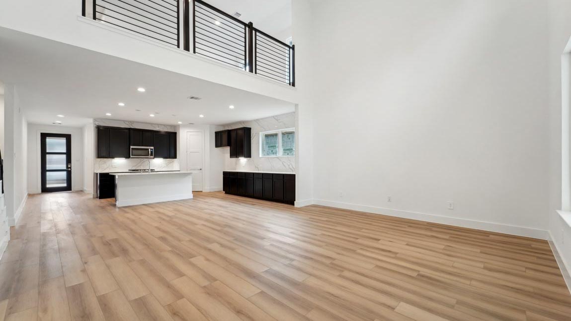 open concept living and dining area with high ceilings, large windows, and vinyl flooring