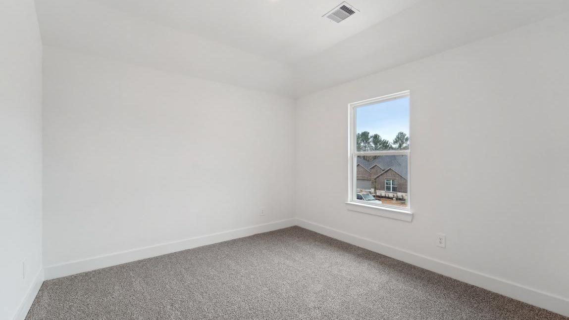 bedroom with carpet flooring and windows