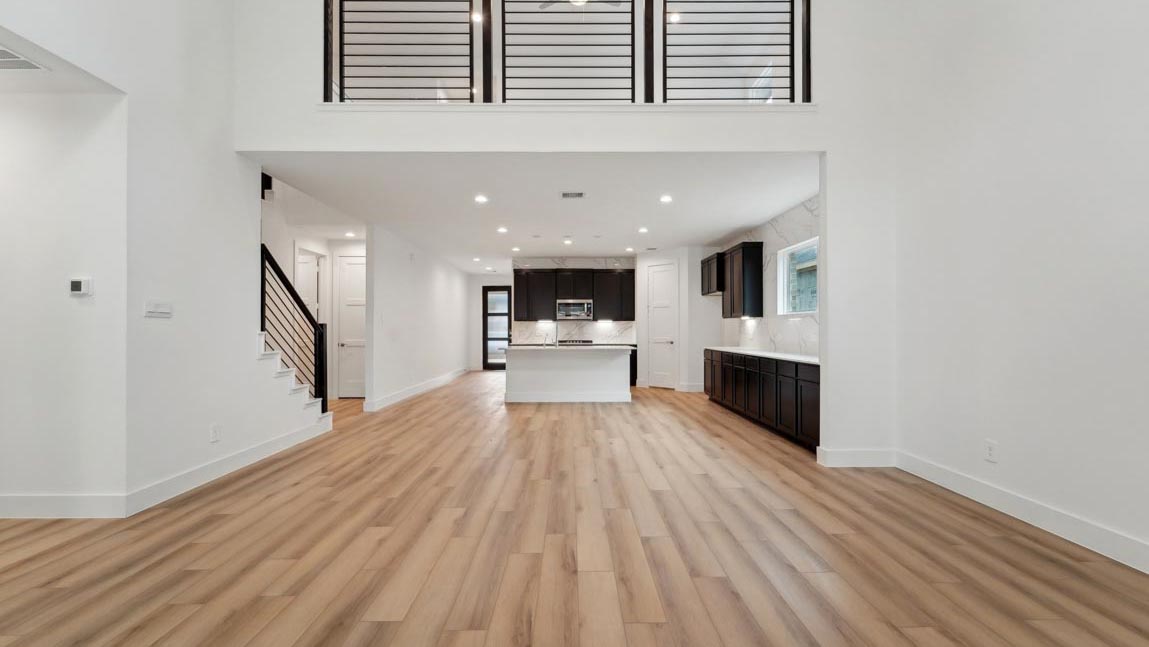 open concept living and dining area with high ceilings, large windows, and vinyl flooring