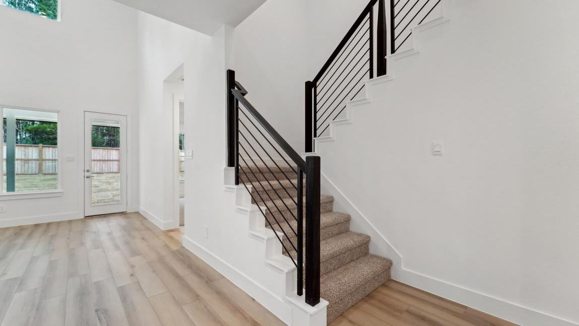 open concept living and dining area with high ceilings, large windows, and vinyl flooring