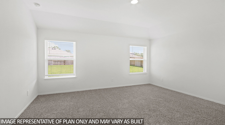 Primary bedroom with two bright windows.