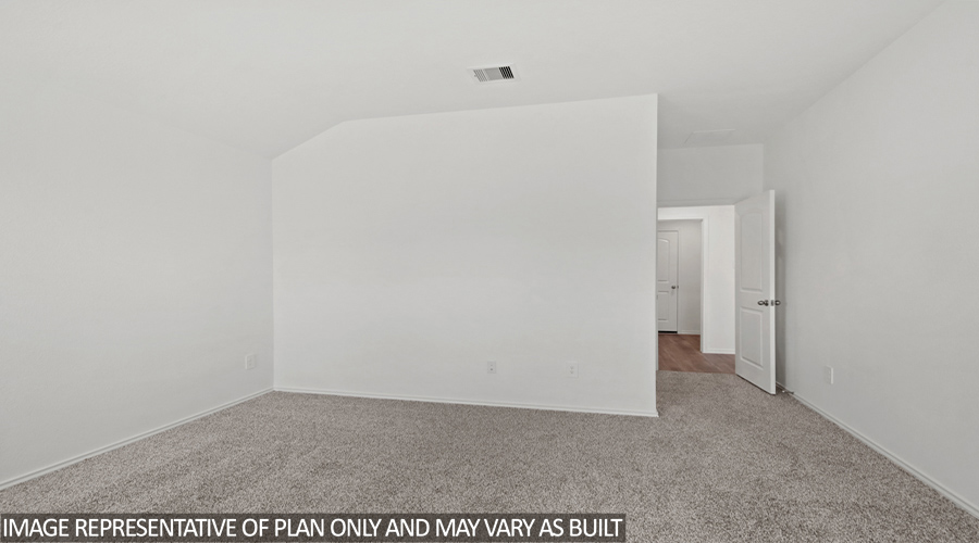 Primary bedroom with carpet flooring.