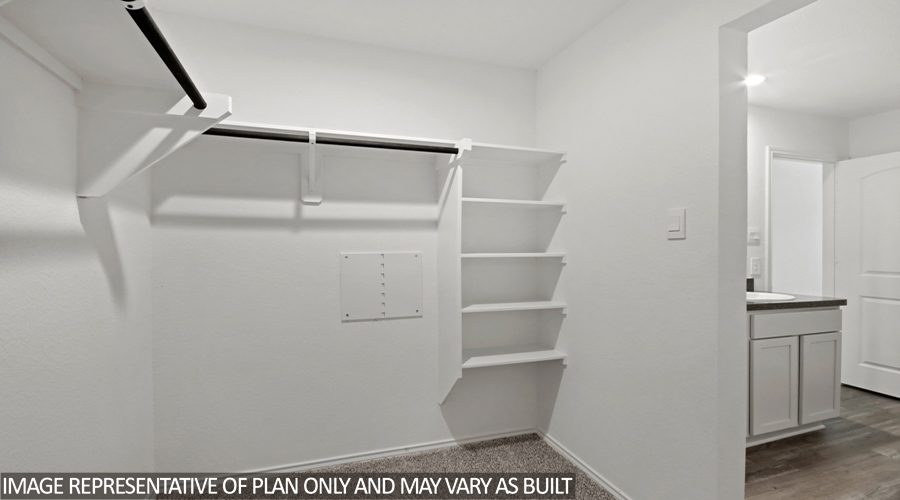 Walk-in closet with storage space.