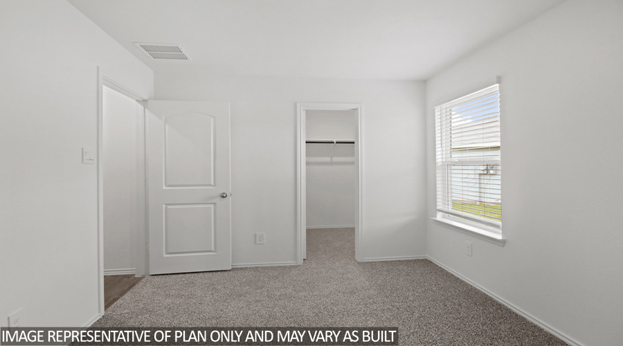 Secondary bedroom with bright window and tall closet.