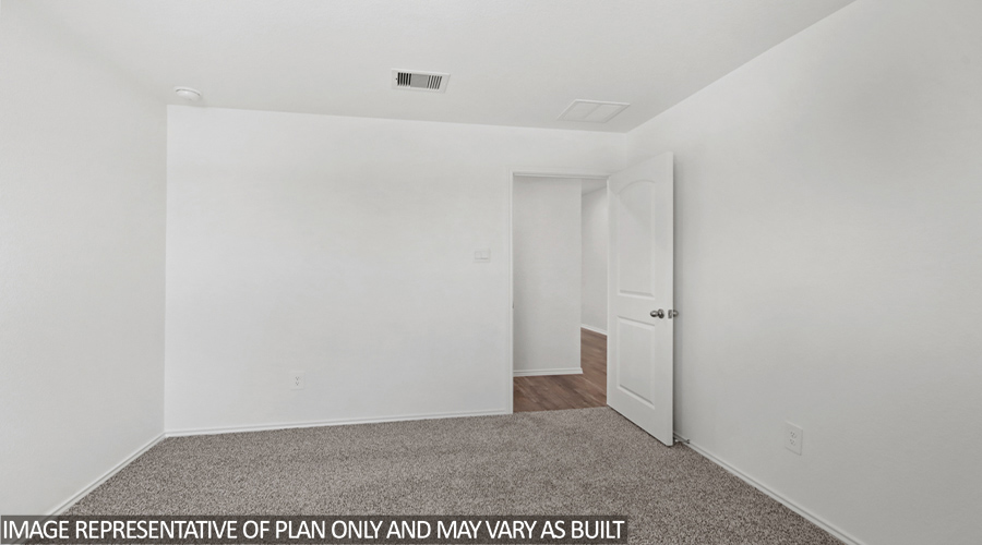 Secondary bedroom with carpet flooring.