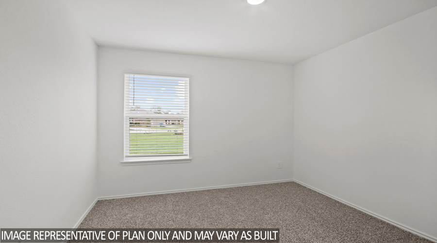 Secondary bedroom with carpet flooring.
