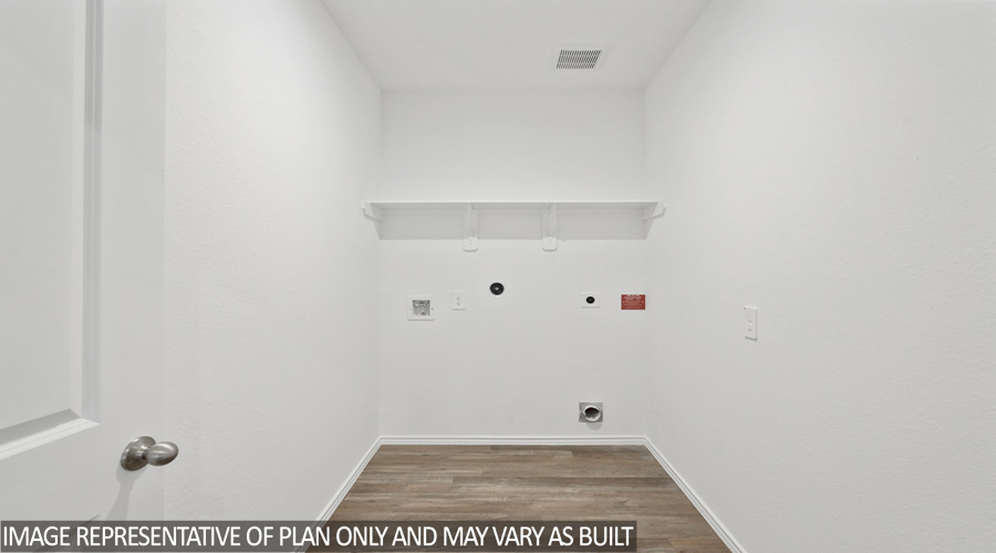 Utility room with overhead storage space.